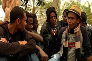 Kidane Isaac speaks to other African refugees
